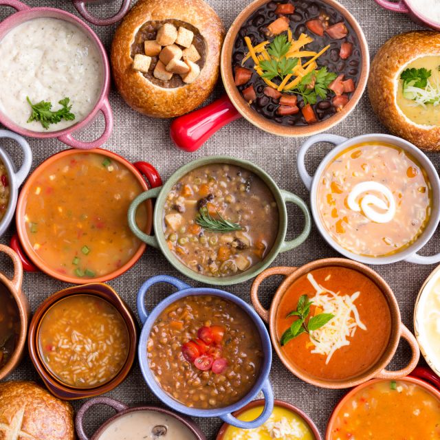 Variety of Garnished Soups in Colorful Bowls